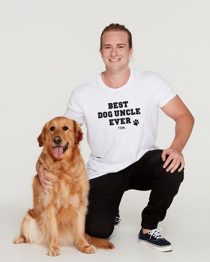 Man wearing a custom “Best Dog Uncle Ever” t-shirt created with Printify print on demand, posing with a golden retriever